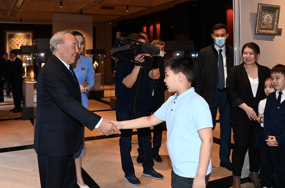 Нурсултан Назарбаев жмет руку ребенку