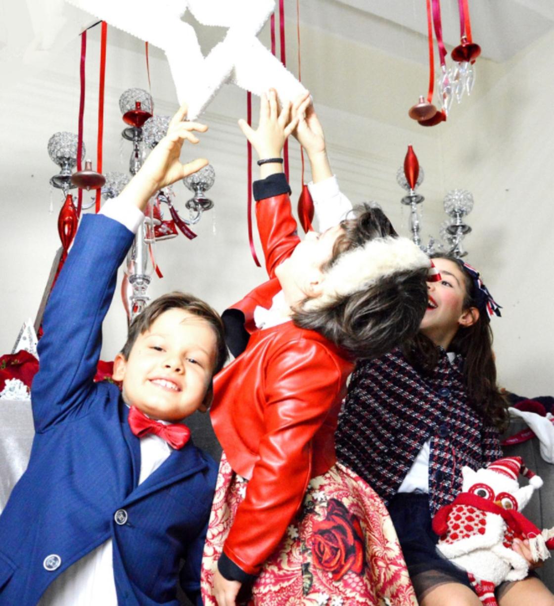 Дети прикасаются к новогодней звезде
