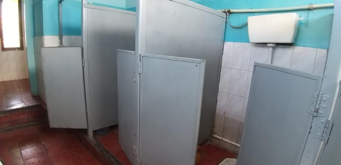 Кабинки туалета, разделенные металлическими дверцами
