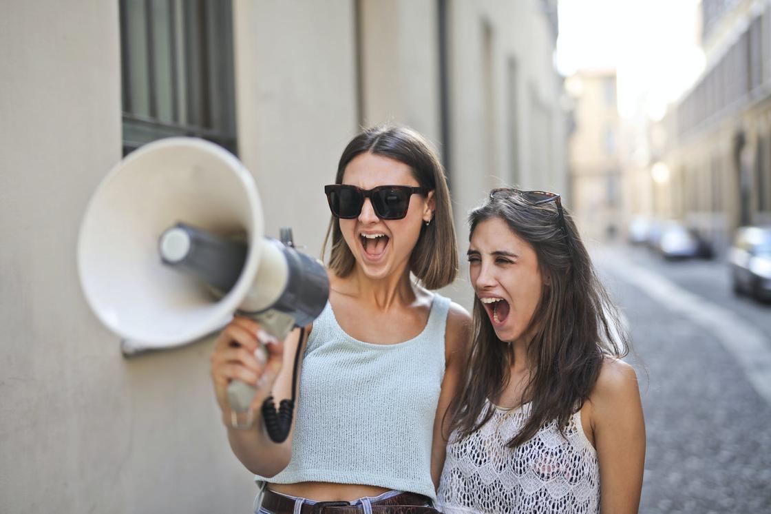 Две девушки с громкоговорителем на улицах города