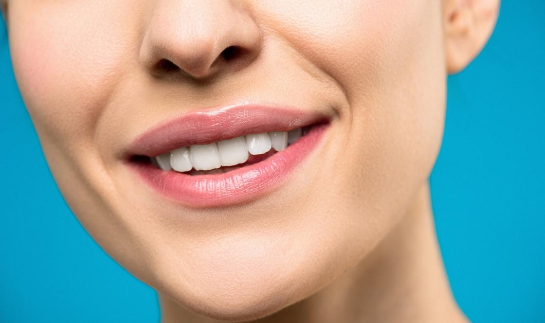 Девушка улыбается, демонстрируя красивые белые зубы и нежные губы