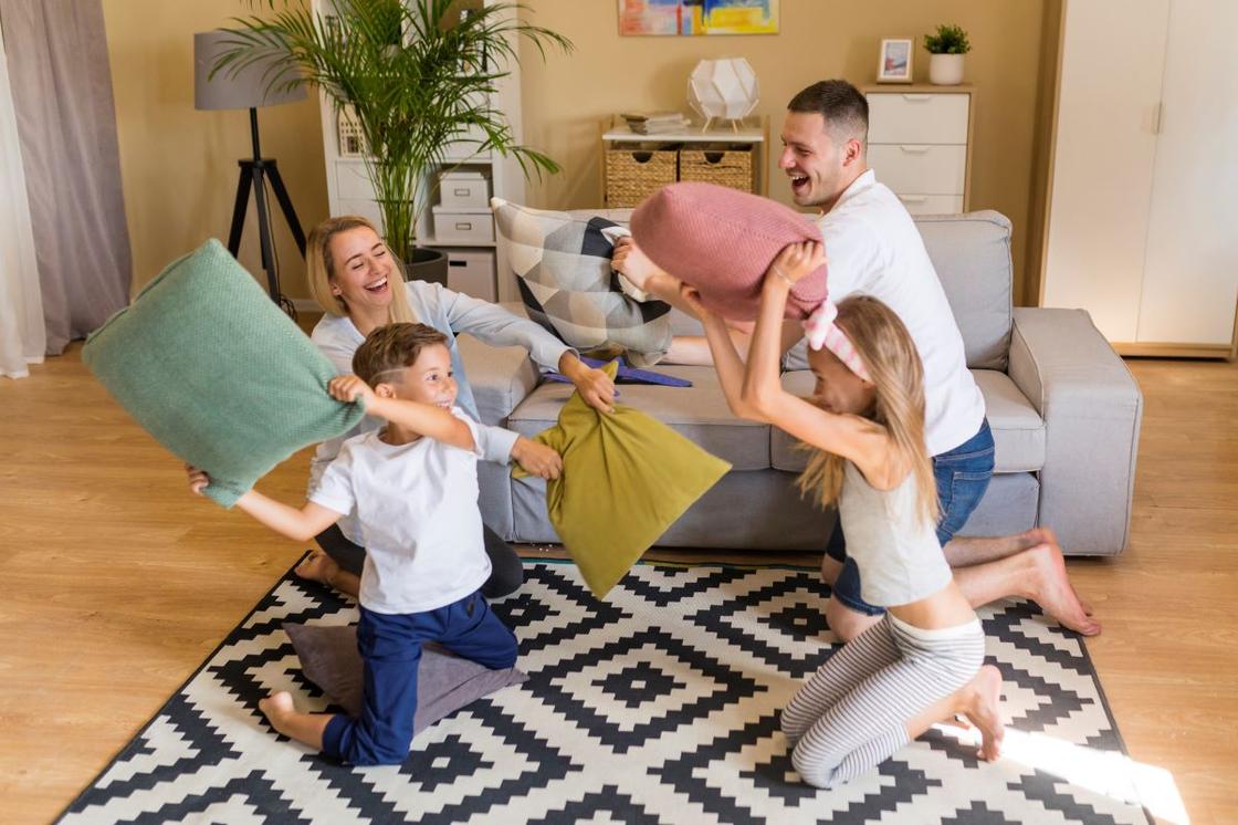 Дети и родители играют с подушками