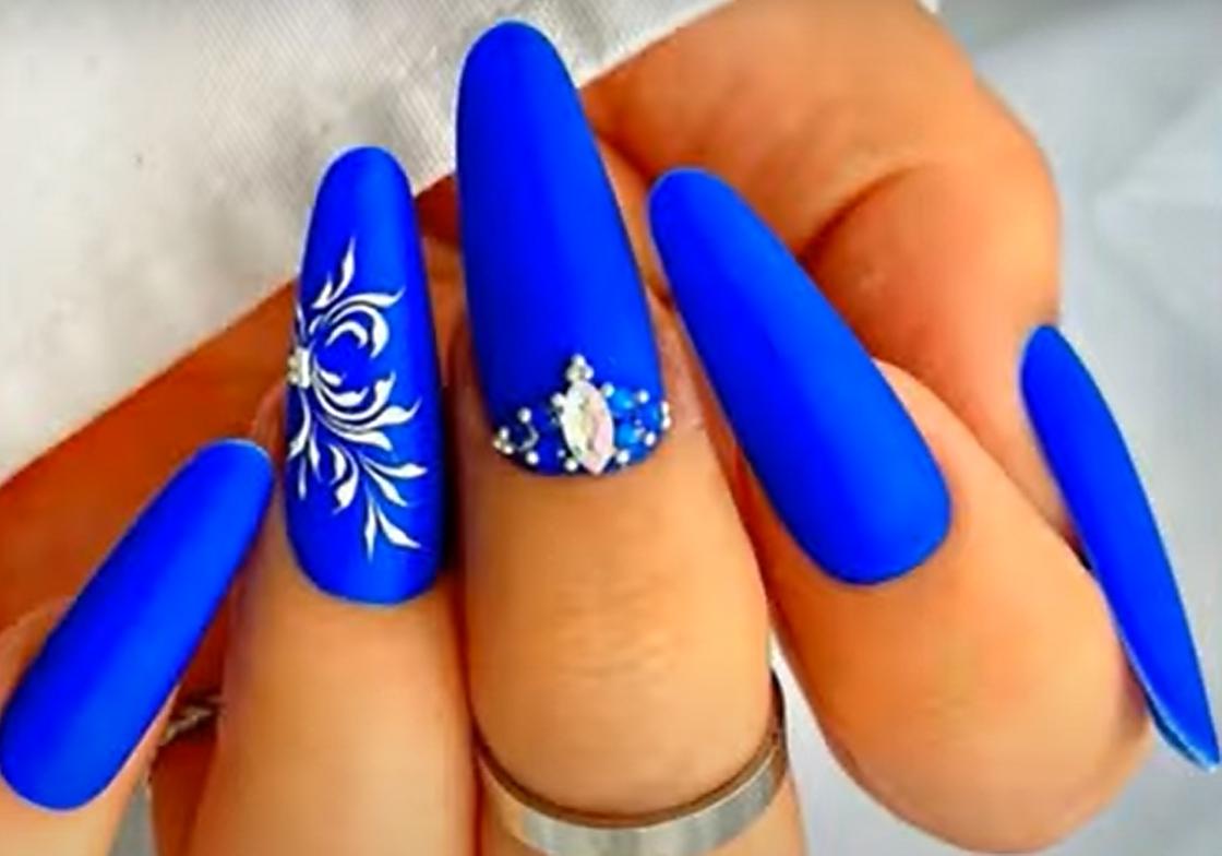 Длинные ногти с синим матовым маникюром, объемными украшениями в виде камней и страз