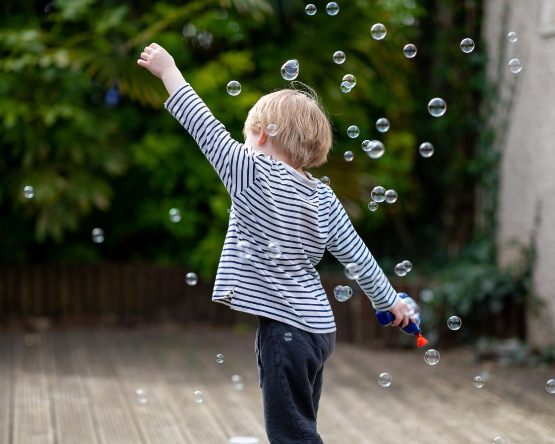 Мальчик делает мыльные пузыри