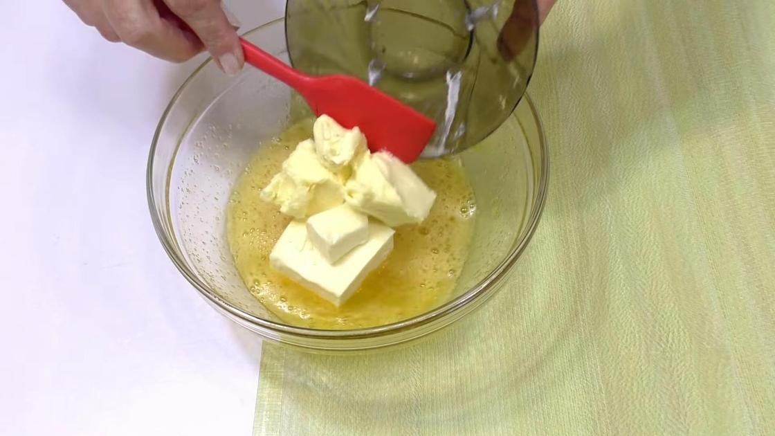 Масло кусочками перекладывают в миску со взбитыми яйцами