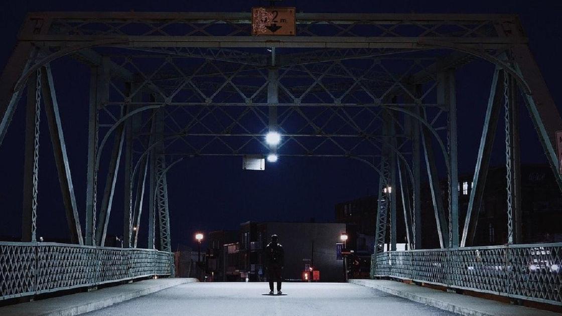 Мужчина стоит на мосту