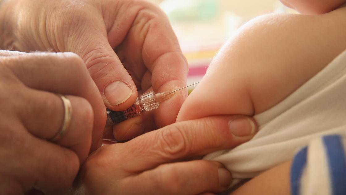 Врач ставит вакцину малышу