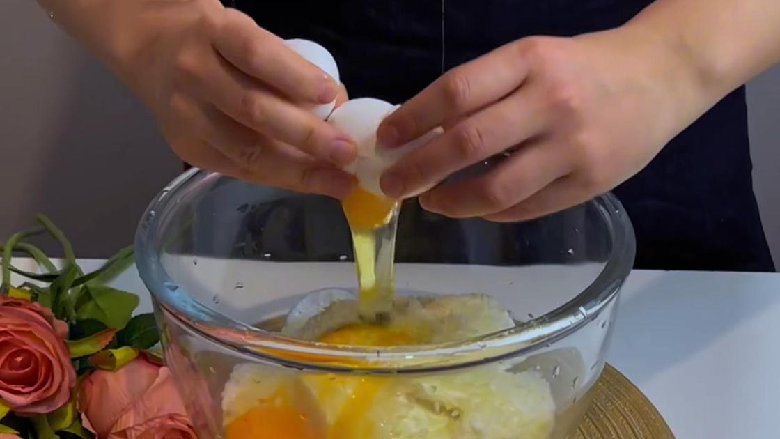 В миску со сливочным сыром и сметаной разбивают куриные яйца