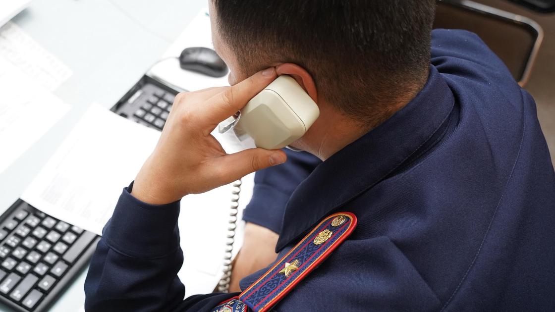 Полицейский говорит по телефону Полицейский говорит по телефону