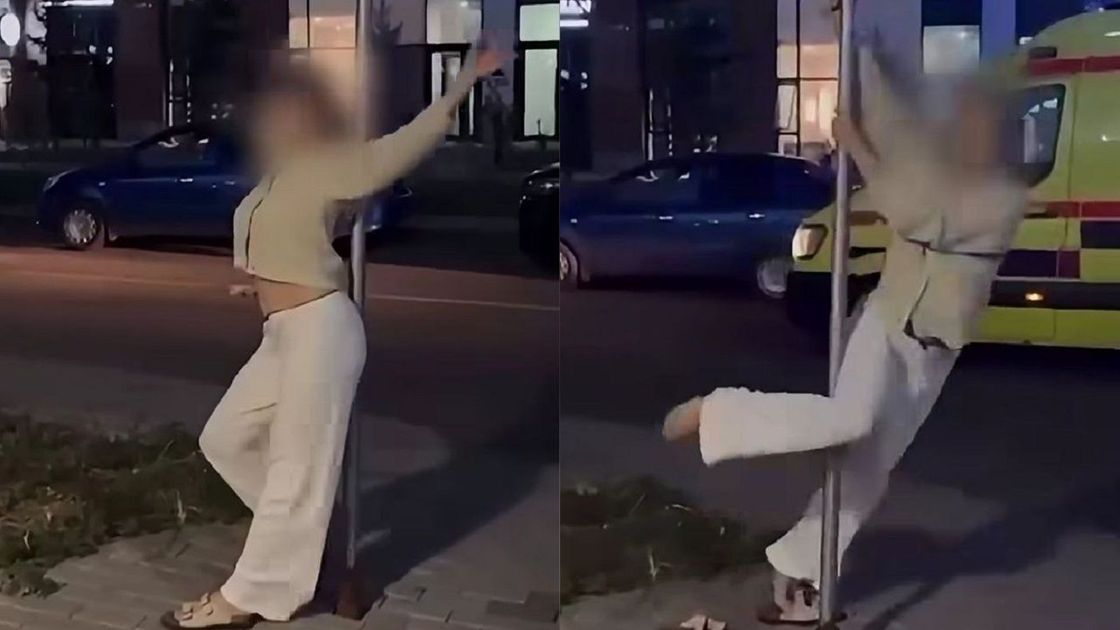 Девушка танцует у дорожного знака