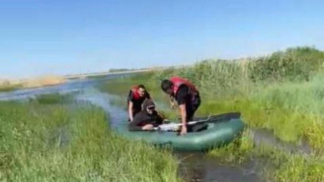 Спасатели возле резиновой лодки