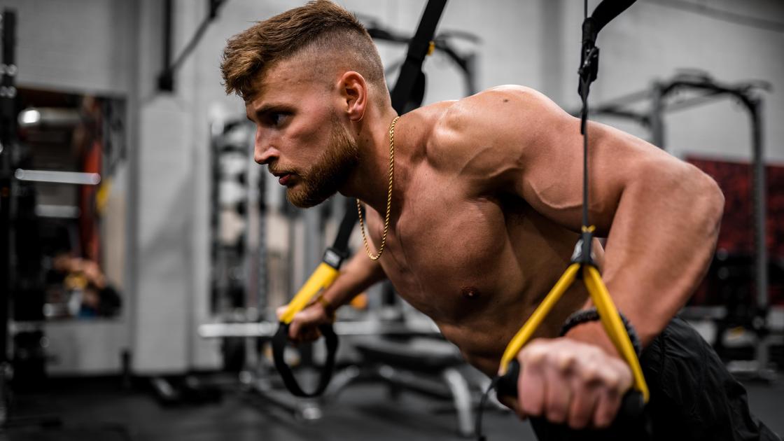 Muž cvičí v tělocvičně