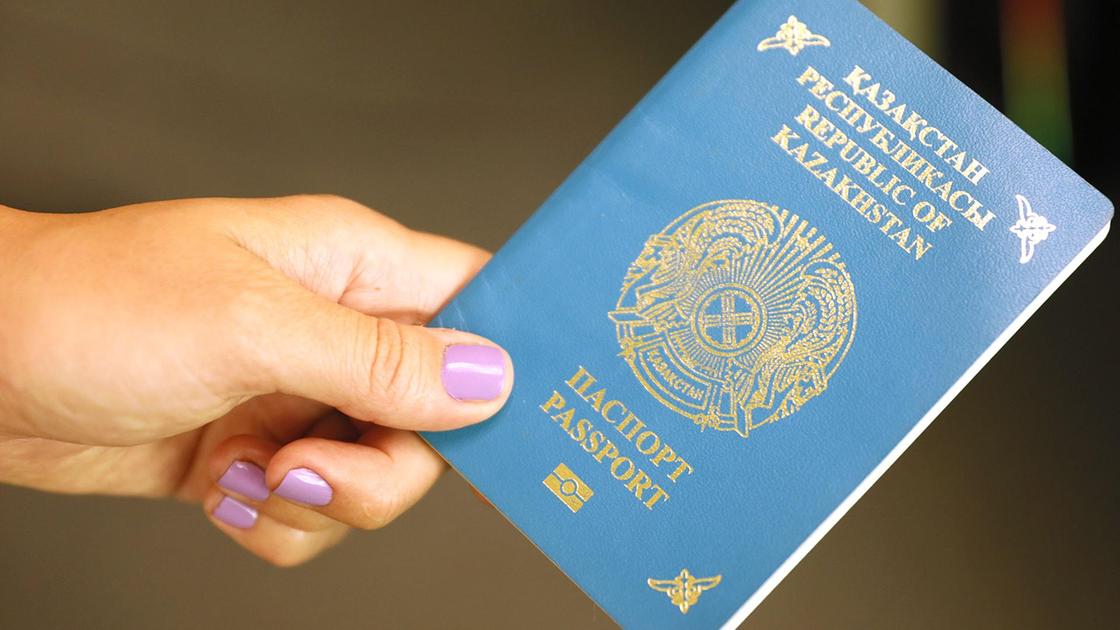 Женщина держит паспорт в руке