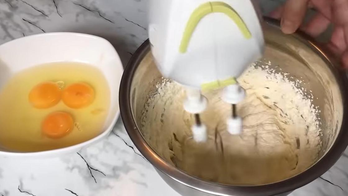 Яйца добавляют ко взбитому маслу и перемешивают