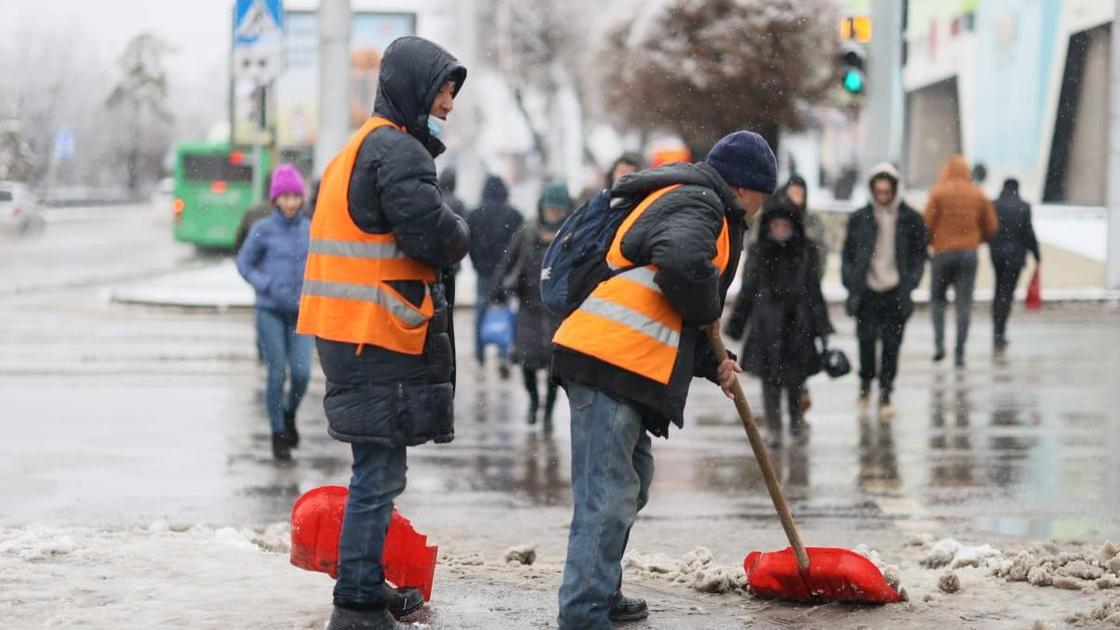 Рабочие убирают снег