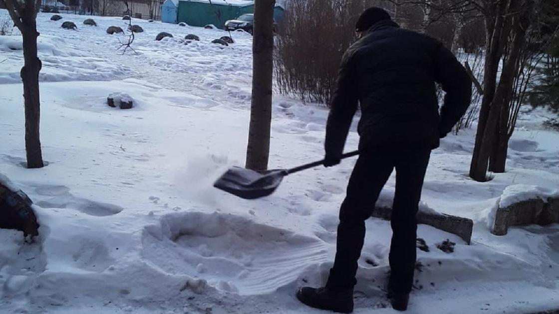 Осужденный убирает снег на улице в Усть-Каменогорске