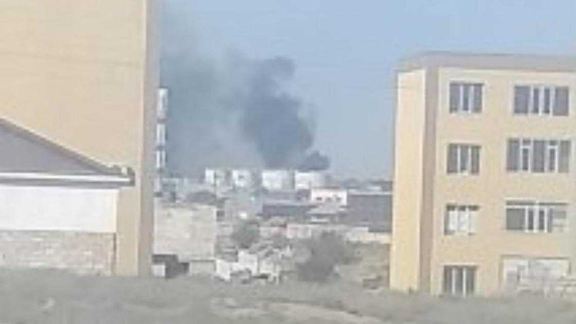 Черный столб дыма над зданиями в Актау