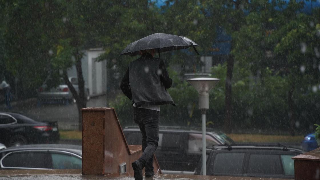 Человек бежит под дождем