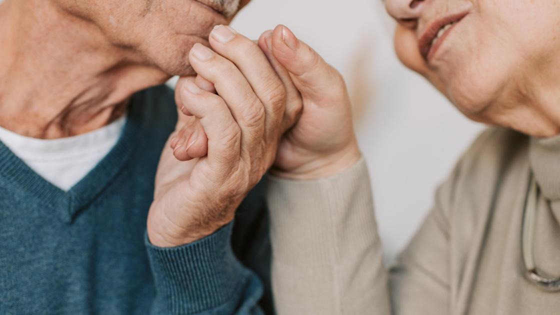 Пожилые мужчина и женщина держатся за руки