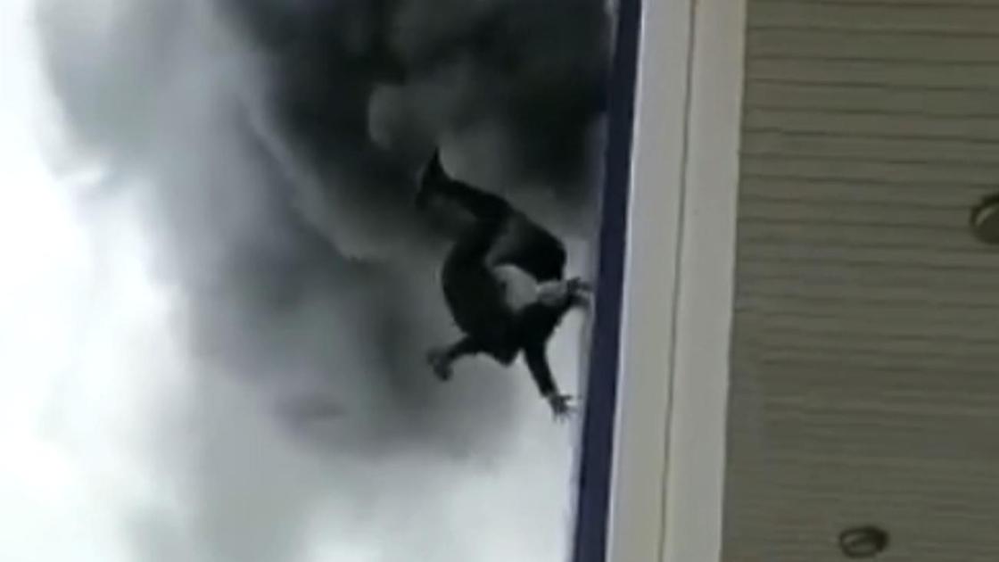 Девушка падает из окна горящего ТЦ