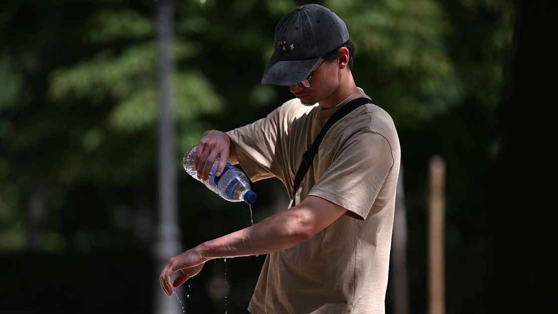 Мужчина льет воду на руки в жару