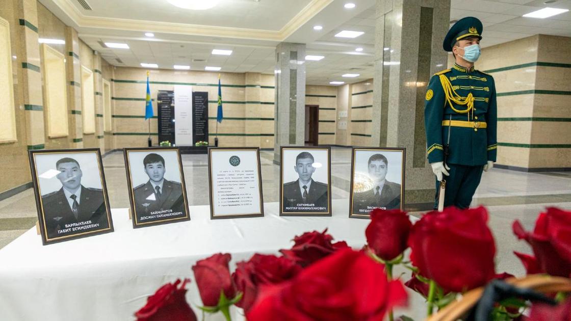 Четыре портрета погибших военных стоят на столе