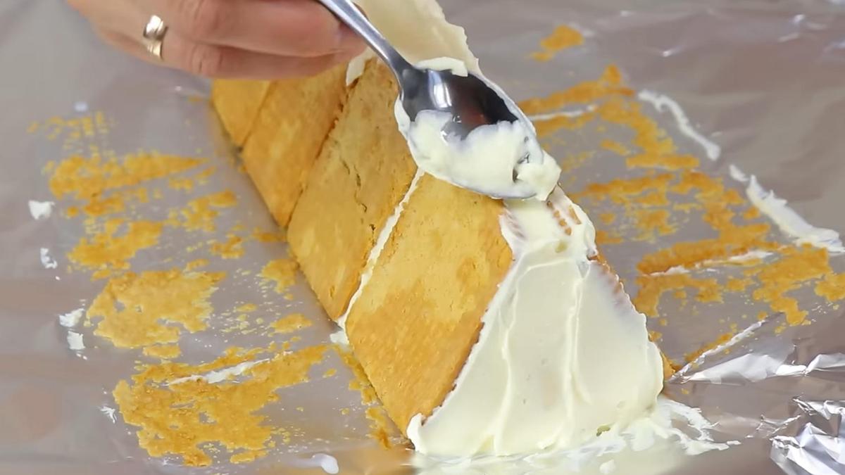 Выравнивание творожного крема на торте чайной ложкой