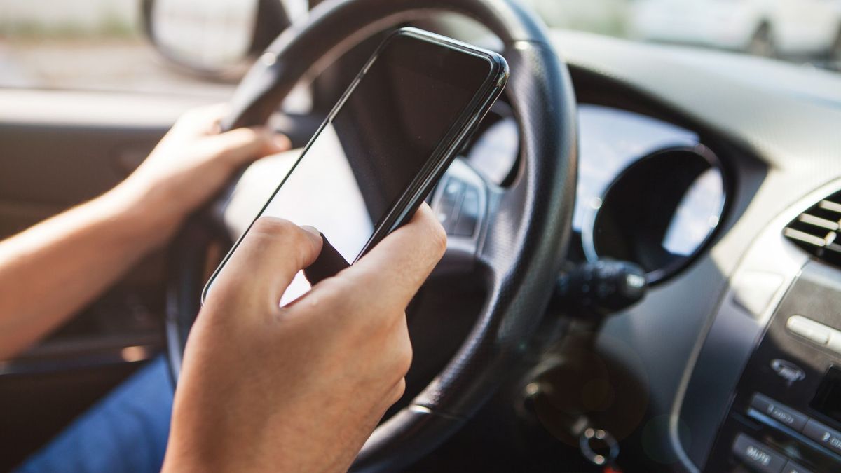 Водитель с телефоном в руках