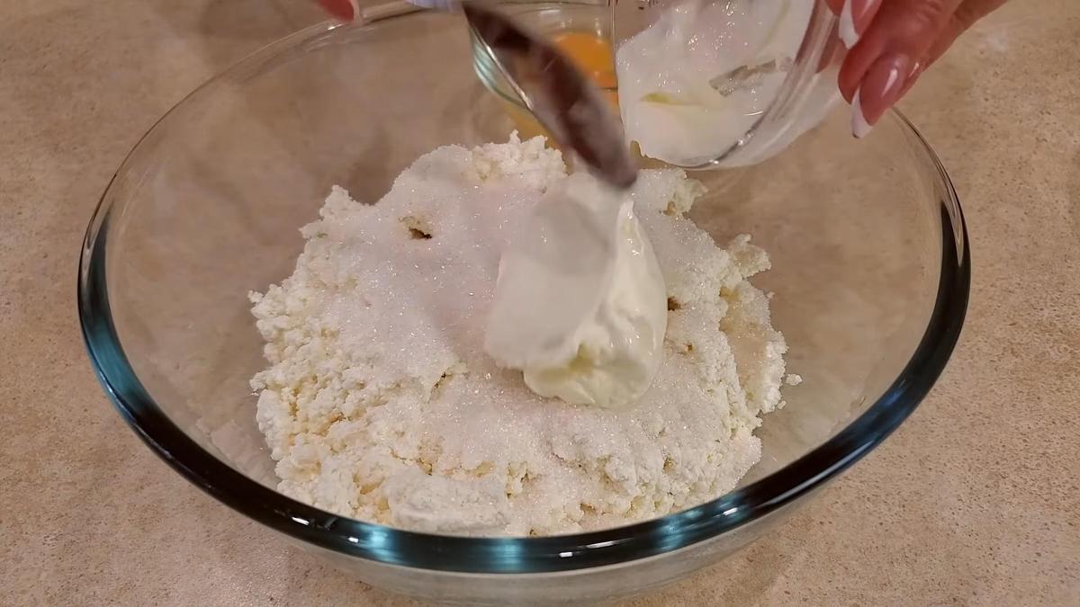 Творог со сметаной и сахаром в миске