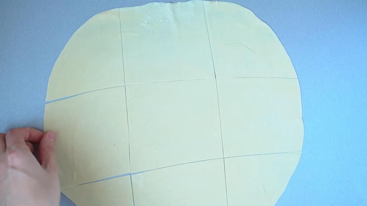 Нарезанное на квадраты тесто на бешбармак