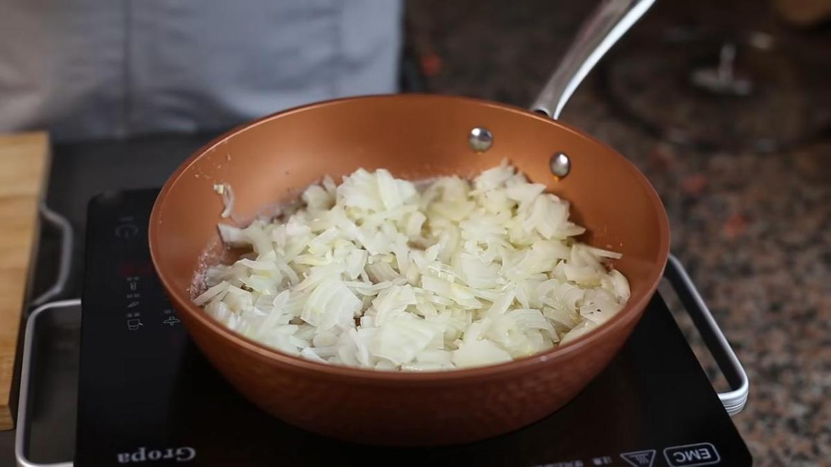 Обжаривание нарезанного лука на сковороде