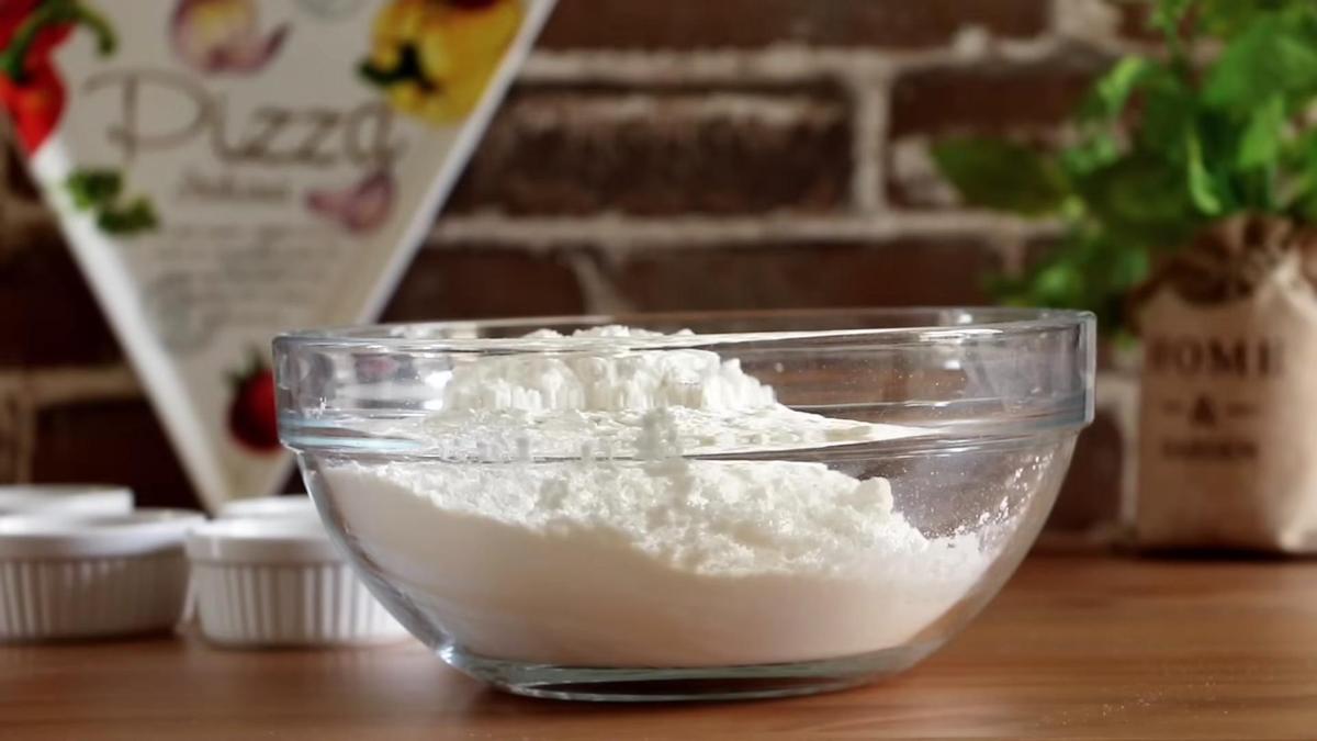 В стеклянной миске смешана мука с дрожжами