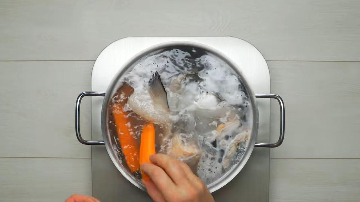 Добавление очищенной моркови в рыбный бульон