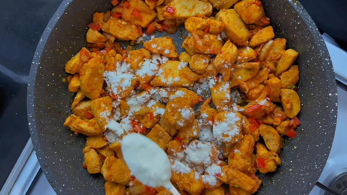 В сковороду с курицей и овощами добавляют муку