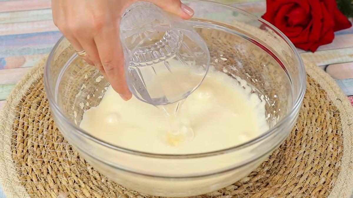 Воду наливают из стакана в емкость со взбитыми желтками