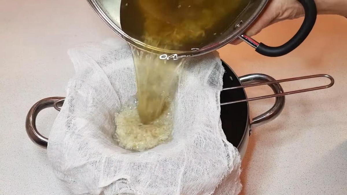 Бульон из кастрюли процеживают через марлю
