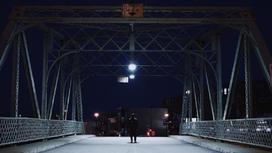 Мужчина стоит на мосту