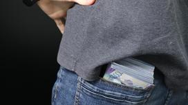 Пачка денег лежит у мужчины в заднем кармане
