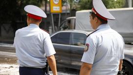 Полицейские в форме стоят на улице со спины