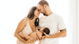 Радостные родители с младенцем