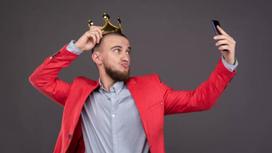 Мужчина фотографирует себя с короной на голове