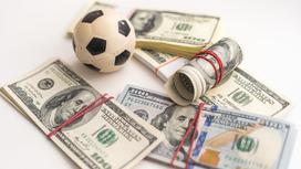 Доллары и игрушечный футбольный мяч