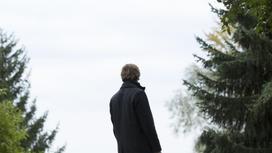 Мужчина стоит возле деревьев