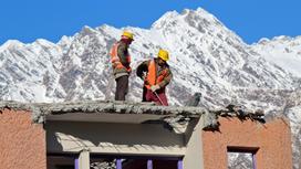 Строители сносят дом в горах