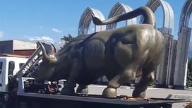 Статуя быка стоит на машине