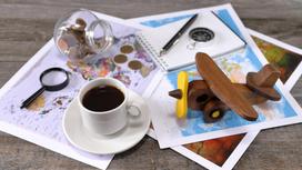 Карта, монеты и чашка кофе на столе