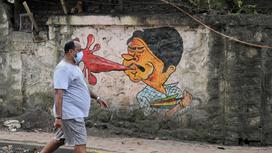 Граффити, изображающее плюющегося человека в Индии