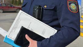 Полицейский держит в руках папку
