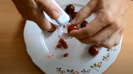 Специальным устройством удаляют косточки с черешен Специальным устройством удаляют косточки с черешен