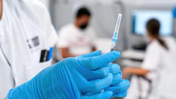 Медработник держит в руках шприц Медработник держит в руках шприц